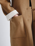 Detail image of model wearing Reversible Double Face Coat in CAMEL / OFF WHITE on CAMEL side