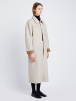 Side full length image of model wearing Reversible Double Face Coat in CAMEL / OFF WHITE on OFF WHITE SIDE