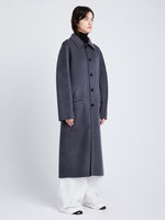 Side full length image of model wearing Reversible Double Face Coat in BLACK / STEEL GREY on STEEL GREY side