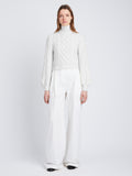 Front full length image of model wearing Chunky Cable Bell Sleeve Sweater in OFF WHITE