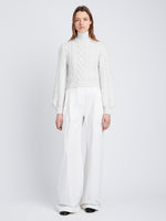 Front full length image of model wearing Chunky Cable Bell Sleeve Sweater in OFF WHITE