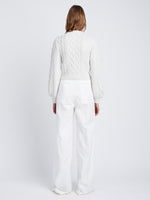 Back full length image of model wearing Chunky Cable Bell Sleeve Sweater in OFF WHITE