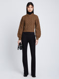 Front full length image of model wearing Chunky Cable Bell Sleeve Sweater in DARK CAMEL