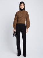 Front full length image of model wearing Chunky Cable Bell Sleeve Sweater in DARK CAMEL