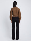 Back full length image of model wearing Chunky Cable Bell Sleeve Sweater in DARK CAMEL