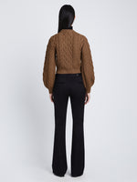 Back full length image of model wearing Chunky Cable Bell Sleeve Sweater in DARK CAMEL