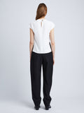 Back full length image of model wearing Matte Viscose Crepe Shell Top in WHITE