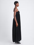 Side image of model in Matte Viscose Crepe Strapless Dress in black