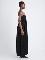 Side image of model in Matte Viscose Crepe Strapless Dress in black