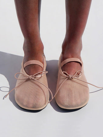 Cropped image of model wearing Glove Mary Jane Ballet Flats in Satin in NUDE