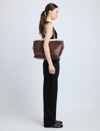 Proenza Schouler side image of model wearing Days Tote in Nappa Shearling in CHESTNUT