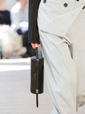 Detail image of model carrying Silo Bag in black in Proenza Schouler SS25 Runway Show