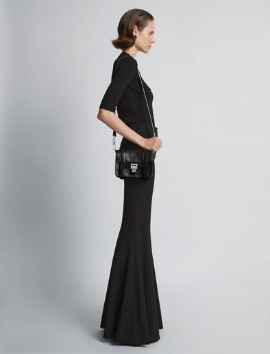 Proenza Schouler Side full length image of model carrying PS1 Mini Crossbody Bag in BLACK