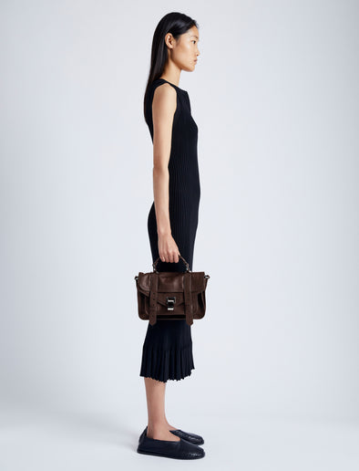 Proenza Schouler side image of model carrying PS1 Tiny Bag in CHESTNUT