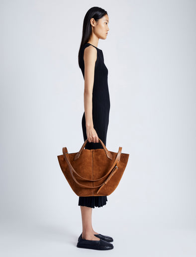 Image of model wearing Large Chelsea Tote In Soft Suede in SADDLE