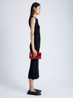 Image of model wearing Flip Shoulder Bag in Eel in ROSEWOOD