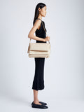 Image of model wearing City Messenger Bag in TAUPE