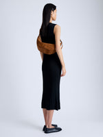 Image of model wearing Slide Bag in Soft Suede in SADDLE