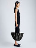 Image of model carrying Large Ruched Tote in Soft Shiny Calf in BLACK