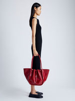 Image of model wearing Large Ruched Tote in Soft Shiny Calf in ROSEWOOD