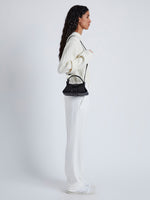 Image of model wearing Mini Park Crossbody Bag in BLACK