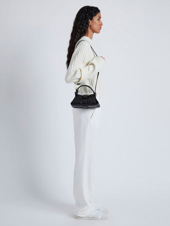 Image of model wearing Mini Park Crossbody Bag in BLACK