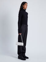 Image of model wearing Silo Bag in Ostrich Embossed Calf in CREAM