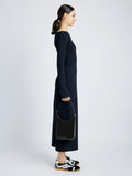 Front full length image of model holding Slope Shoulder Bag In Soft Spazzolato in BLACK