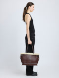 Proenza Schouler side image of model carrying Days Tote in Nappa Shearling in CHESTNUT