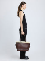 Proenza Schouler side image of model carrying Days Tote in Nappa Shearling in CHESTNUT