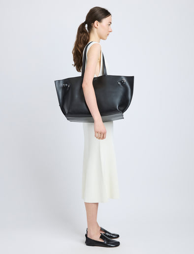 Proenza Schouler image of model carrying Days Carryall in Smooth Calf in black