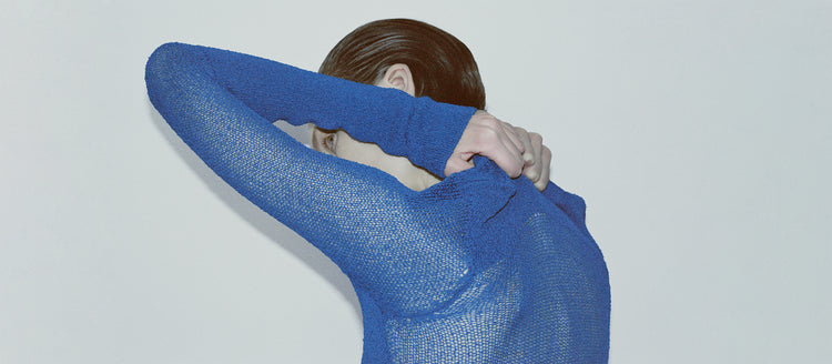 Cropped image of model's back wearing Anita Dress in Knit Sheer Mesh in bright blue