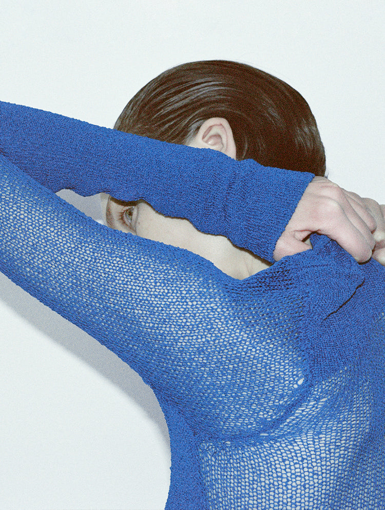 Cropped image of model's back wearing Anita Dress in Knit Sheer Mesh in bright blue