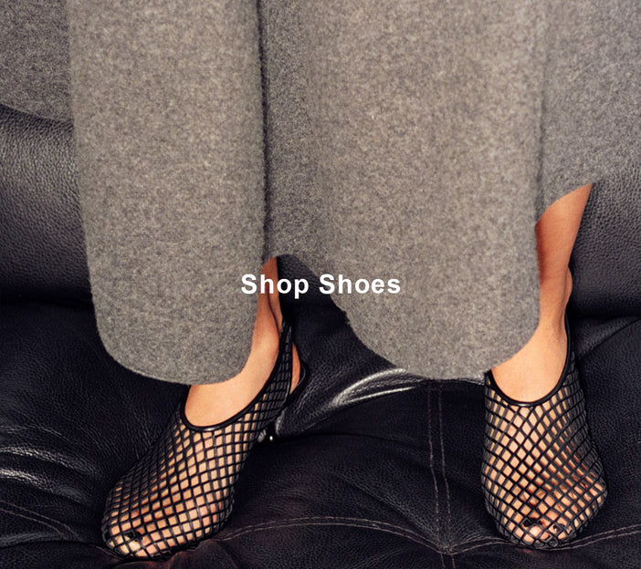 Cropped image of model wearing Tee Perforated Slingback Pumps in black, 'Shop Shoes' overlaid