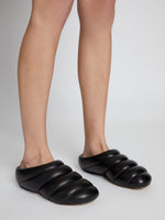 Cropped image of model wearing Puffy Rondo Slippers in BLACK