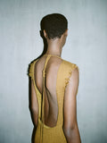 Cropped image of a model wearing Silvia Backless Dress In Silk Doubleface Boucle in cider.