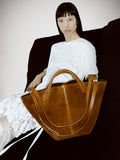 Cropped image of model wearing Olson T-Shirt in Eco Cotton Jersey in white with Large Chelsea Tote in Suede in saddle.