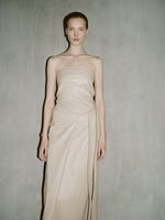 Cropped image of a model wearing Delancy Dress in Glossy Leather in nude.