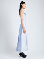 Side image of model wearing Ruby Dress in Eco Stretch Linen Viscose in sky blue