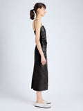 Side image of model wearing Delancy Dress in Glossy Leather in black