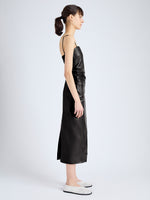 Side image of model wearing Delancy Dress in Glossy Leather in black