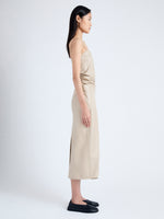 Side image of model wearing Delancy Dress in Glossy Leather in NUDE