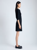 Side full length image of model wearing Goldie Dress in Matte Viscose Crepe in BLACK