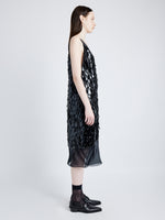 Side image of model wearing Irene Dress in Resin Embroidered Organza in BLACK