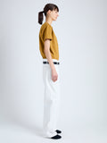 Side full length image of model wearing Kira T-Shirt in Eco Cotton Jersey in CIDER