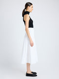 Side image of model wearing Moore Skirt in Organic Cotton Twill in off white