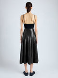 Back image of model wearing Moore Skirt in Glossy Leather in BLACK