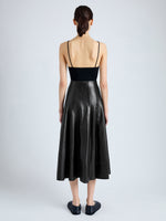 Back image of model wearing Moore Skirt in Glossy Leather in BLACK