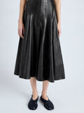 Detail image of model wearing Moore Skirt in Glossy Leather in BLACK