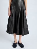 Detail image of model wearing Moore Skirt in Glossy Leather in BLACK